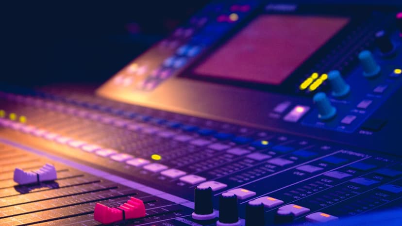 Audio engineer at a professional mixing console during a live concert